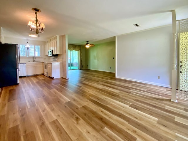 103 Peartree Cir, Dothan, AL 36301 - unfurnished living room featuring a chandelier, a sink, light wood-style flooring, and baseboards