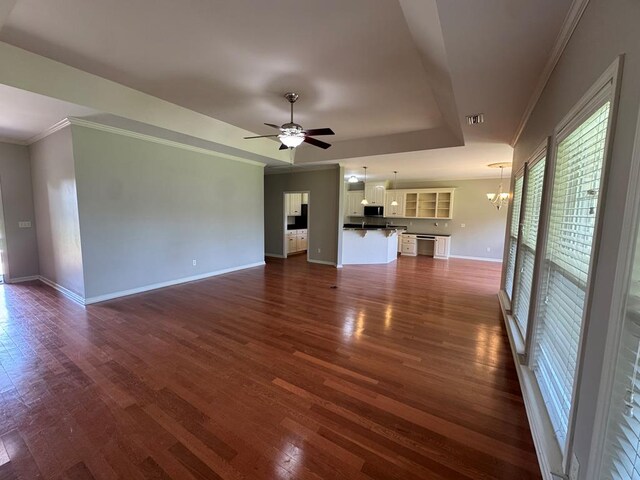 108 Sunshine Ln, Dothan, AL 36303 - unfurnished living room with a chandelier, crown molding, dark wood-type flooring, baseboards, and ceiling fan