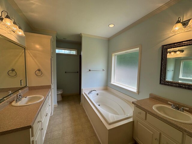 108 Sunshine Ln, Dothan, AL 36303 - bathroom featuring toilet, two vanities, a bath, ornamental molding, and baseboards
