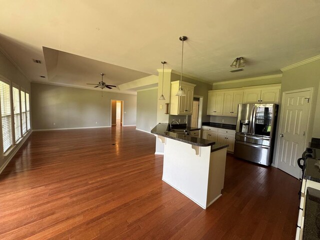 108 Sunshine Ln, Dothan, AL 36303 - kitchen featuring stainless steel fridge, a peninsula, a kitchen breakfast bar, open floor plan, and dark countertops