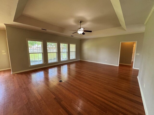 108 Sunshine Ln, Dothan, AL 36303 - spare room featuring a ceiling fan, dark wood-type flooring, baseboards, a raised ceiling, and crown molding