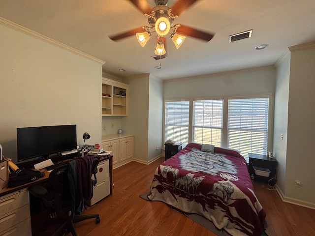 bedroom featuring ornamental molding, visible vents, and wood finished floors