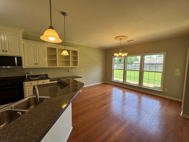 108 Sunshine Ln, Dothan, AL 36303 - kitchen featuring stainless steel microwave, stove, a chandelier, open shelves, and baseboards