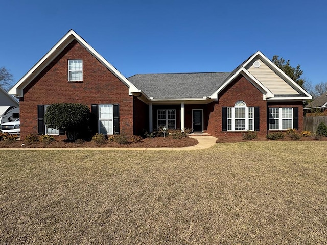 view of front of property with a front yard and brick siding