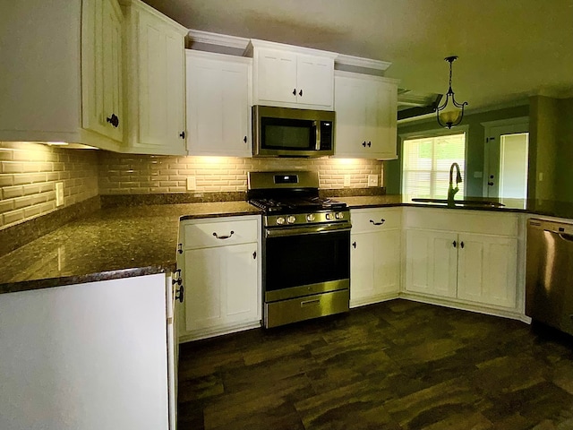 503 Cedar Grove Ln, Enterprise, AL 36330 - kitchen with appliances with stainless steel finishes, white cabinets, decorative backsplash, dark wood-style flooring, and decorative light fixtures