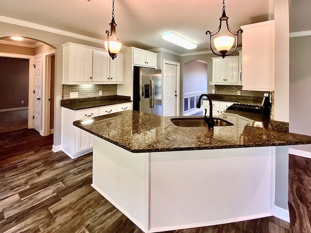 503 Cedar Grove Ln, Enterprise, AL 36330 - kitchen featuring stainless steel refrigerator with ice dispenser, arched walkways, crown molding, white cabinets, and decorative backsplash