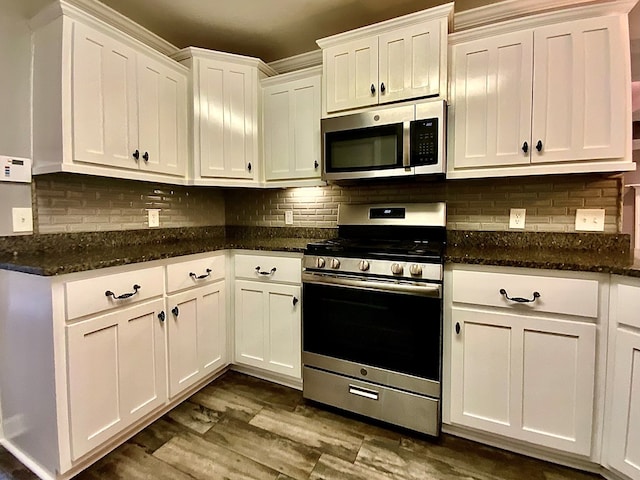 503 Cedar Grove Ln, Enterprise, AL 36330 - kitchen featuring appliances with stainless steel finishes, white cabinets, tasteful backsplash, dark wood finished floors, and dark stone counters