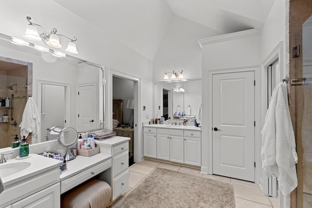 bathroom with tile patterned flooring, vanity, and vaulted ceiling