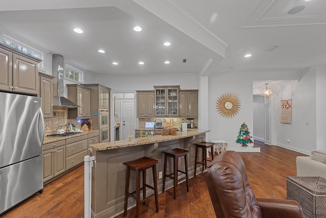 kitchen with stainless steel appliances, tasteful backsplash, a kitchen breakfast bar, light stone counters, and dark hardwood / wood-style floors