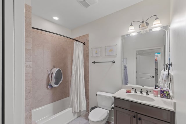 full bathroom featuring shower / bath combo, vanity, and toilet