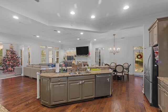 kitchen featuring stainless steel appliances, a kitchen island with sink, and dark wood-type flooring