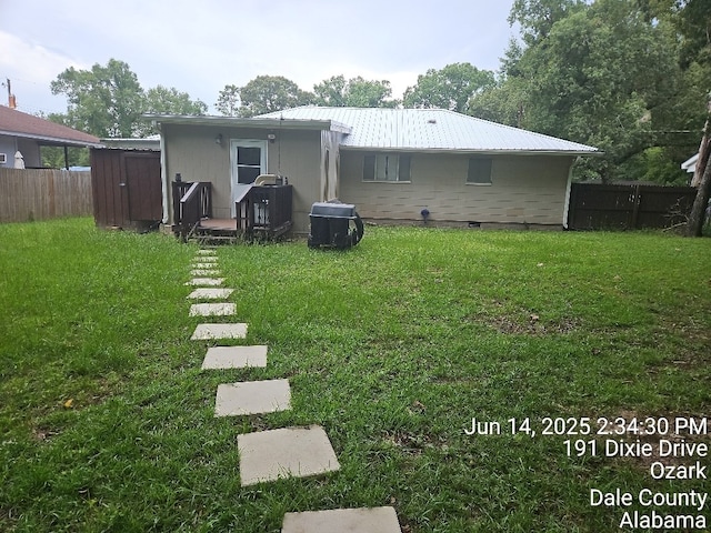 179 Dixie Dr, Ozark, AL 36360 - rear view of house with a metal roof and a storage unit