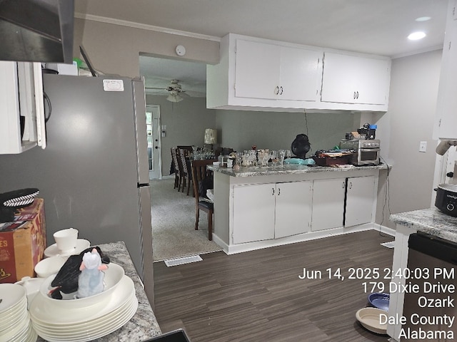 179 Dixie Dr, Ozark, AL 36360 - kitchen with ornamental molding, ceiling fan, white cabinets, dark wood finished floors, and freestanding refrigerator