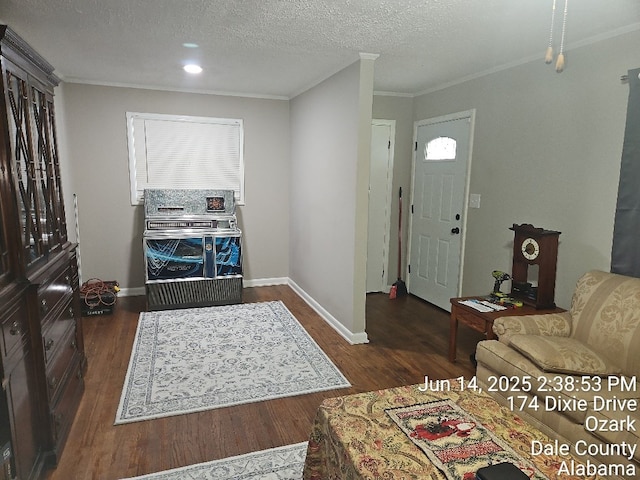 179 Dixie Dr, Ozark, AL 36360 - foyer featuring dark wood-style floors, crown molding, heating unit, plenty of natural light, and a textured ceiling