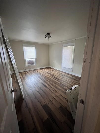 spare room featuring cooling unit and hardwood / wood-style flooring