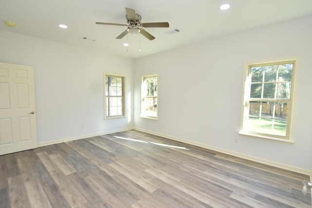 unfurnished room with ceiling fan and hardwood / wood-style floors