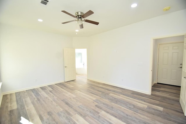 empty room with ceiling fan and hardwood / wood-style flooring