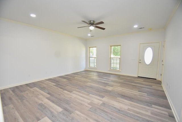 entryway featuring hardwood / wood-style flooring, ceiling fan, and crown molding