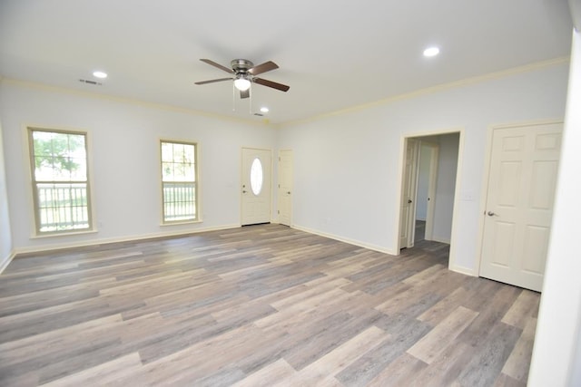 interior space with hardwood / wood-style flooring, ceiling fan, and ornamental molding