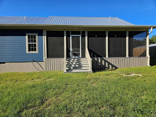 back of property featuring a sunroom and a yard