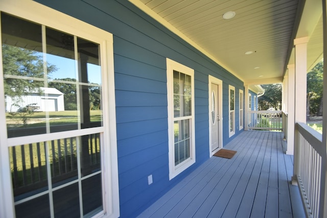 wooden terrace featuring covered porch