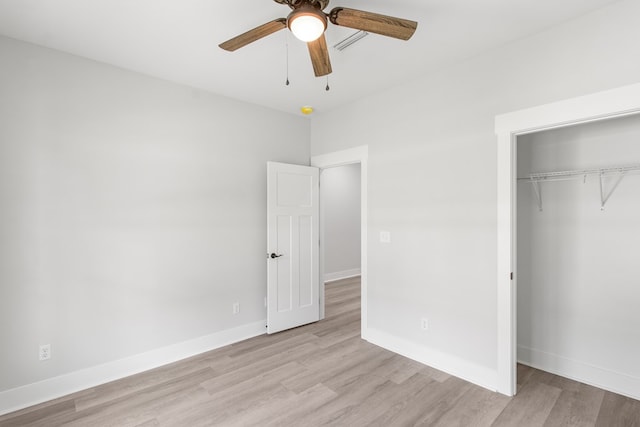 unfurnished bedroom featuring ceiling fan, light hardwood / wood-style floors, and a closet