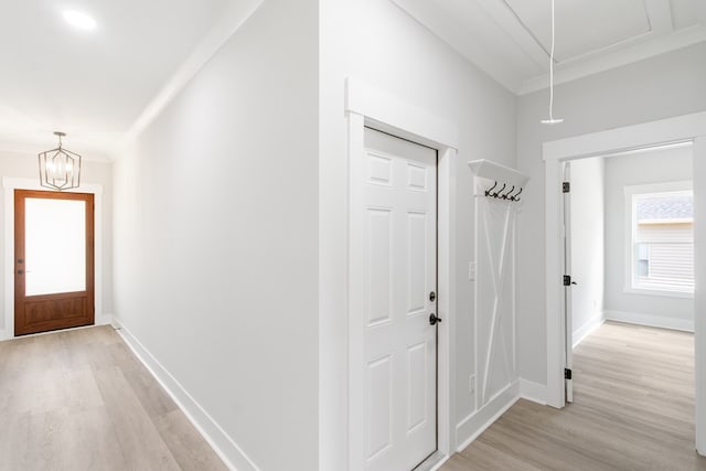 foyer entrance featuring light hardwood / wood-style floors and an inviting chandelier