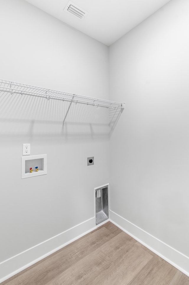 laundry room featuring wood-type flooring, hookup for a washing machine, and electric dryer hookup