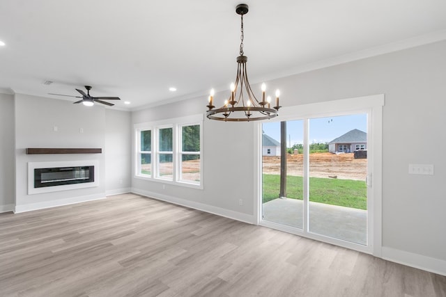 interior space featuring ornamental molding, ceiling fan with notable chandelier, and light wood-type flooring