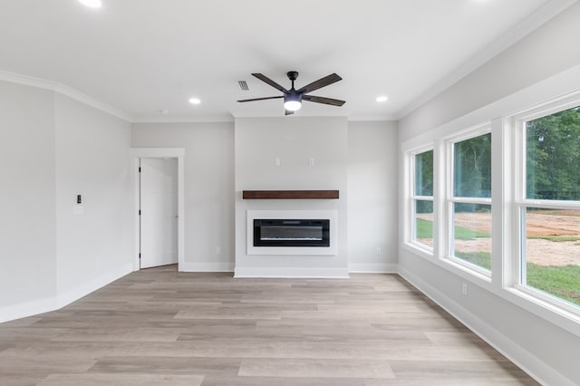 unfurnished living room featuring ceiling fan, light wood-type flooring, and ornamental molding