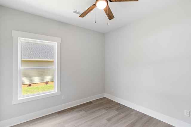 empty room with ceiling fan and light hardwood / wood-style floors