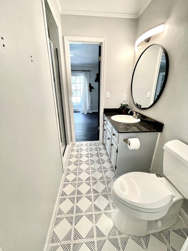 bathroom with walk in shower, vanity, crown molding, tile patterned flooring, and toilet