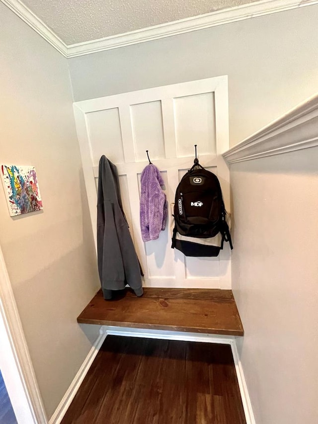 mudroom with a textured ceiling, dark hardwood / wood-style floors, and ornamental molding