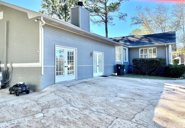 rear view of property featuring french doors and a patio