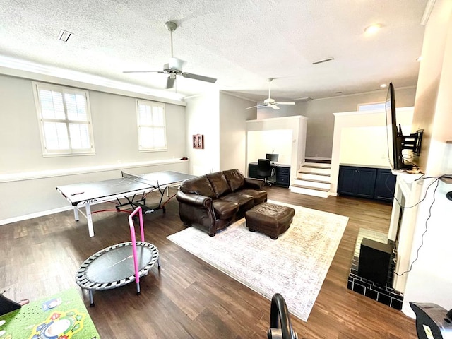 game room featuring a textured ceiling and dark wood-type flooring