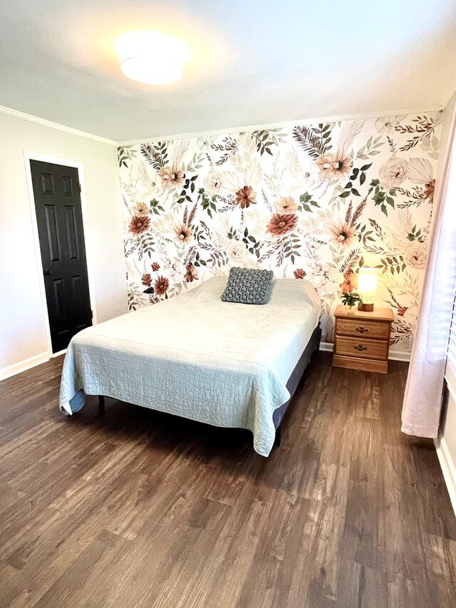 bedroom featuring dark hardwood / wood-style floors and ornamental molding