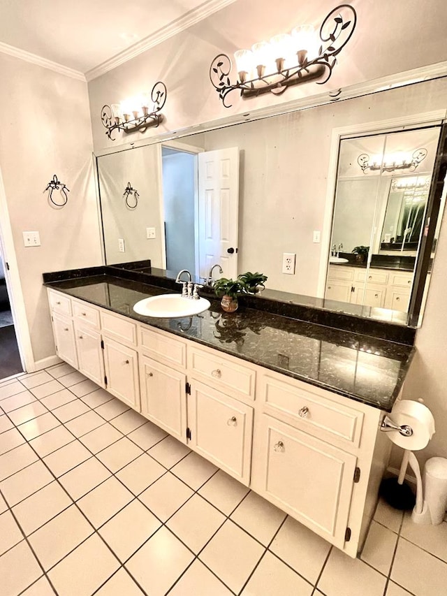 bathroom featuring vanity, tile patterned floors, and crown molding