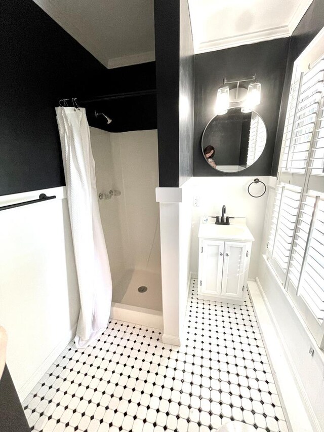 bathroom featuring curtained shower, vanity, and ornamental molding