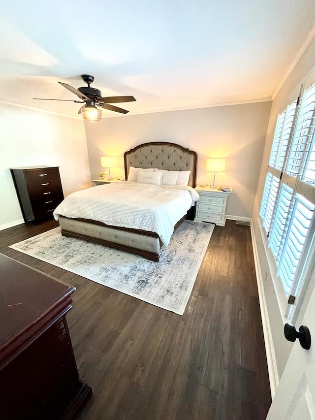 bedroom with dark hardwood / wood-style flooring, ceiling fan, and ornamental molding