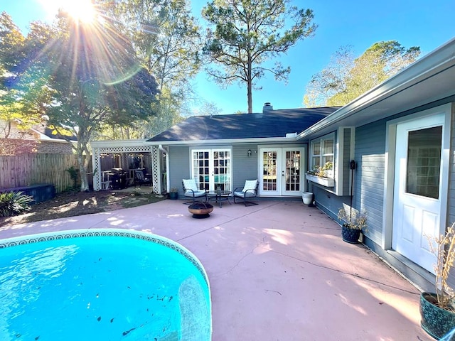 view of swimming pool with a patio area and french doors