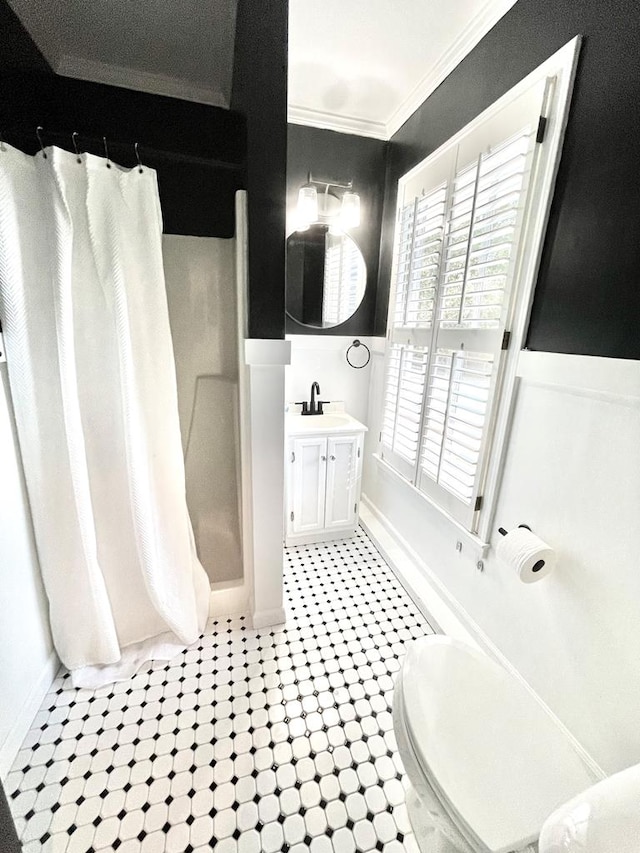 bathroom featuring vanity, curtained shower, and ornamental molding