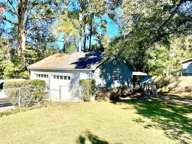 view of side of property with a yard and a garage