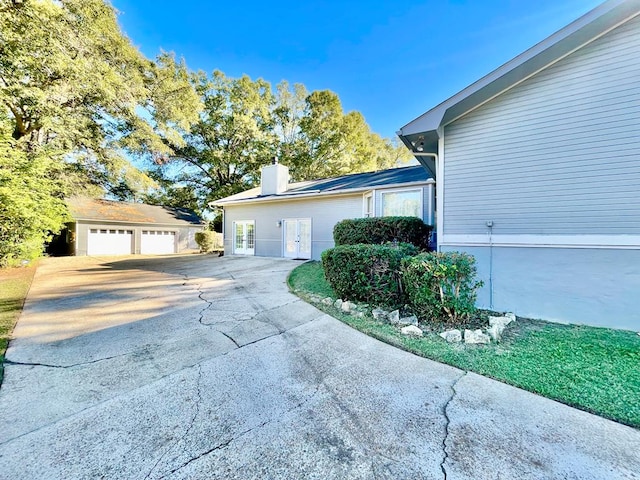 view of property exterior with an outdoor structure