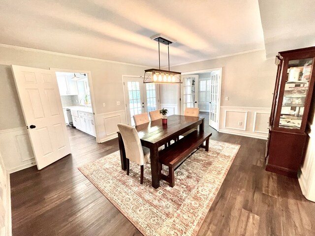 dining space with dark hardwood / wood-style flooring, ceiling fan, french doors, and ornamental molding