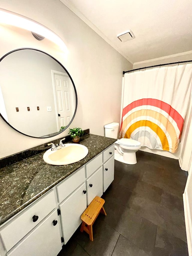 bathroom with vanity, toilet, and ornamental molding