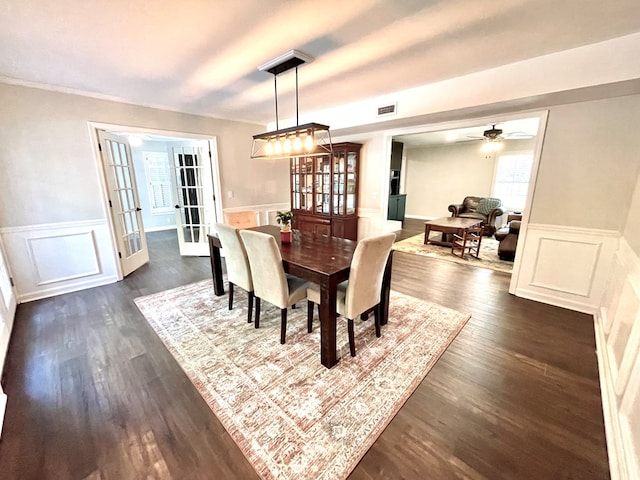 dining space with dark hardwood / wood-style floors, ceiling fan, and french doors