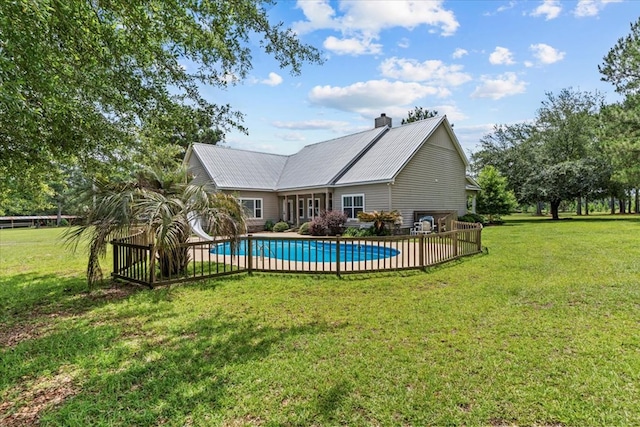 3195 Singletary Rd, Slocomb, AL 36375 - rear view of house with a chimney, a yard, a metal roof, and a garage