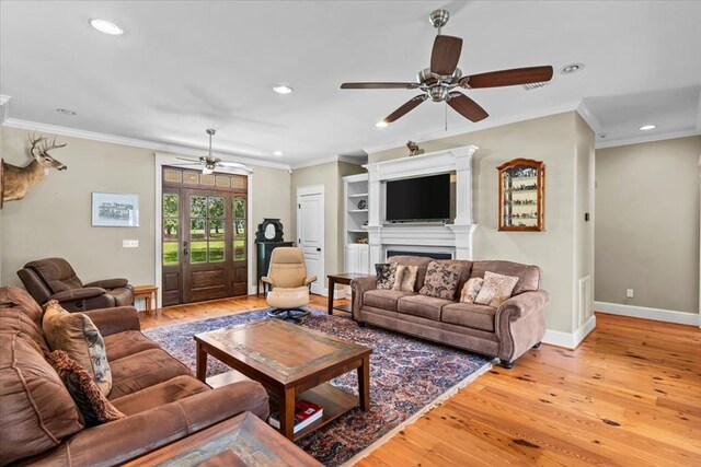 3195 Singletary Rd, Slocomb, AL 36375 - living area with a ceiling fan, light wood finished floors, recessed lighting, ornamental molding, and a fireplace