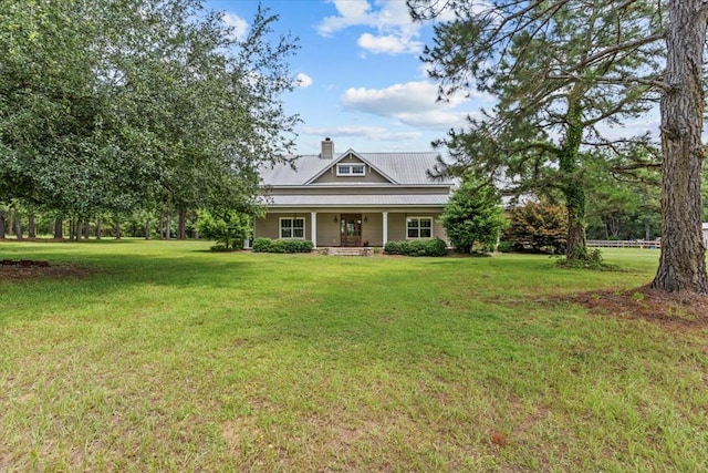 3195 Singletary Rd, Slocomb, AL 36375 - farmhouse with a porch, a chimney, a front yard, and a metal roof