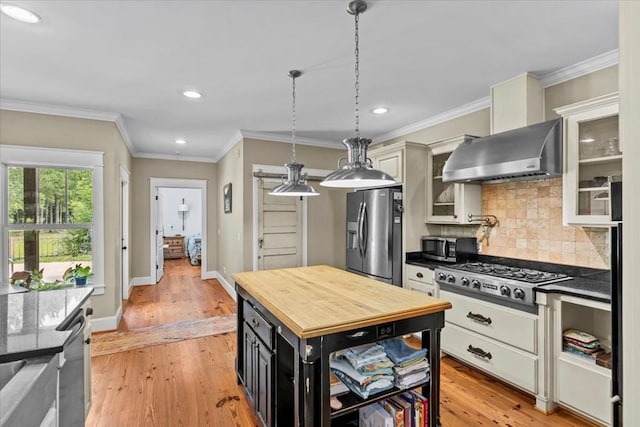 3195 Singletary Rd, Slocomb, AL 36375 - kitchen with wall chimney exhaust hood, stainless steel appliances, recessed lighting, tasteful backsplash, and light wood-type flooring